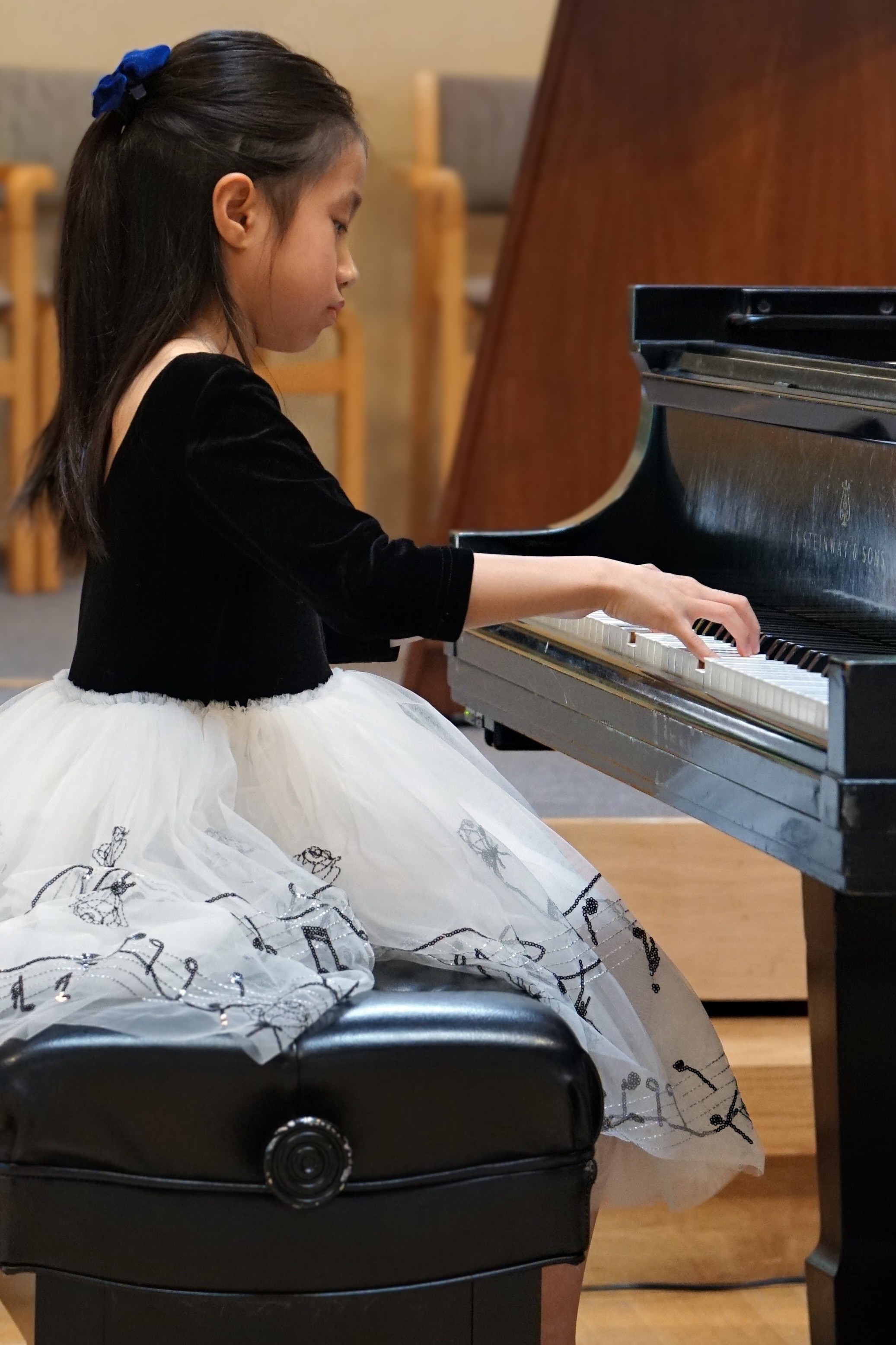Dr. VanPelt guiding a student's hands at the piano